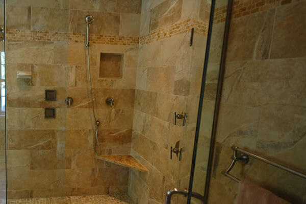 Brown tile with angles glass enclosure shower area