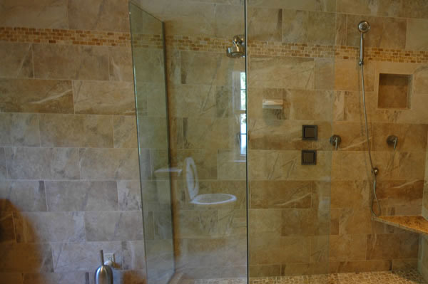 Brown tile with angles glass enclosure shower area