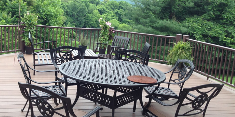 Deck with chairs and table off of screened porch