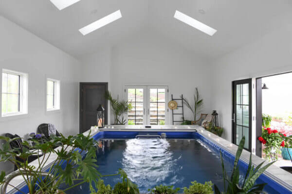 Lots of plants around the pool really enhance the look and feel of the indoor space