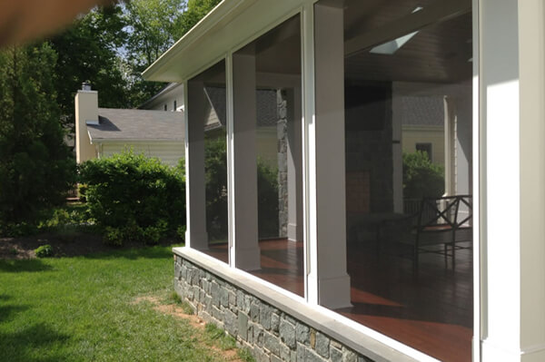 Outside view of screened porch with fireplace